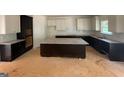Spacious kitchen featuring dark wood cabinets, granite countertops, and a large center island at 3292 Mill Forest Sw Dr, Conyers, GA 30094