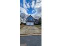 Charming two-story home features a two-car garage, lovely landscaping, and welcoming curb appeal at 1230 Chris Lake Dr, Lawrenceville, GA 30046
