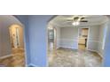Open-concept living space features neutral paint, tile floors, and arched doorways that add architectural interest at 1230 Chris Lake Dr, Lawrenceville, GA 30046