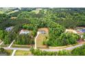A beautiful home surrounded by lush greenery and mature trees in a serene neighborhood at 155 Grace Hope Dr, Brooks, GA 30205