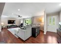 Spacious living room with wood floors, a cozy sectional sofa, and a large window for natural light at 1533 High Haven Ne Ct, Atlanta, GA 30329