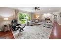 Inviting living room featuring a comfortable chair, ottoman, and large windows for outdoor views at 1533 High Haven Ne Ct, Atlanta, GA 30329