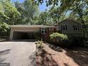 Inviting home with a well-maintained lawn, complemented by a garage and a landscaped entrance at 261 Sally Duke Dr, Whitesburg, GA 30185