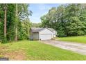 Charming home featuring an attached two car garage, a well-maintained lawn, and mature trees at 160 Country Mill Ln, Stockbridge, GA 30281