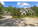 Charming home with well-manicured lawn, lush landscaping, and a detached garage with an upstairs apartment at 193 Stonegate Trl, Carrollton, GA 30116