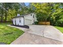 Spacious two-car garage with extended driveway and manicured lawn at 111 Rosignol Dr, Sharpsburg, GA 30277