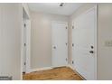Neutral entryway with new wood flooring and white doors at 1368 Poplar Se Pointe, Smyrna, GA 30082