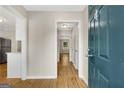 Inviting entryway with wood flooring, a view of the hallway, and neutral paint at 1368 Poplar Se Pointe, Smyrna, GA 30082