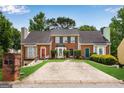 Brick townhouses featuring a shared driveway, manicured lawns, and inviting curb appeal at 1368 Poplar Se Pointe, Smyrna, GA 30082