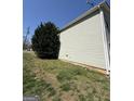 Siding view of a home with a well-maintained lawn and foliage at 132 Scarlett Place Dr, Bowdon, GA 30108