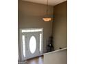 The foyer features a white front door with sidelights and a decorative transom window, plus an elegant light fixture at 1432 Eagles Nest Cir, Carrollton, GA 30116