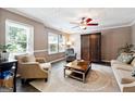 Cozy living room with neutral tones, recessed lighting, ceiling fan, large windows, and comfortable seating arrangement at 4031 E Meadow Dr, Duluth, GA 30096