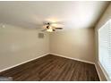Cozy bedroom featuring neutral paint, modern ceiling fan and beautiful wood-look floors at 3730 Stephanie Sw Dr, Atlanta, GA 30331