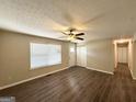 Bright living room boasts a ceiling fan, neutral paint, wood-look flooring and great natural light at 3730 Stephanie Sw Dr, Atlanta, GA 30331