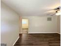 Spacious living room featuring dark wood-look floors and a modern ceiling fan at 3730 Stephanie Sw Dr, Atlanta, GA 30331