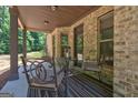 Comfortable covered porch with outdoor seating and overhead lighting at 2360 Braunsroth Ln, Hampton, GA 30228