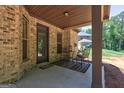 Inviting covered back porch with outdoor seating, perfect for relaxing and enjoying the outdoors at 2360 Braunsroth Ln, Hampton, GA 30228