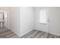 Bright entryway showcasing modern gray floors and a white door at 303 Limestone Circle, Conyers, GA 30013