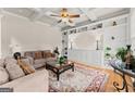 Cozy living room boasting custom built-ins, coffered ceilings, comfortable seating, and a large decorative rug at 2100 Willshire Gln, Alpharetta, GA 30009