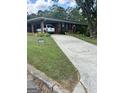 Charming brick home featuring a well-maintained lawn, long drive, and covered parking at 2334 Connally Dr, East Point, GA 30344