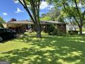 Charming brick home featuring a well-maintained lawn and covered parking at 2334 Connally Dr, East Point, GA 30344