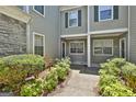 Inviting entryway showcasing a well-maintained walkway, landscaped bushes and gray siding at 508 Las Brasis Ct, Peachtree City, GA 30269