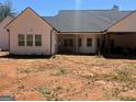 An exterior view of the home's backyard with a covered patio and plenty of room at 1333 Happy Hill Rd, Carrollton, GA 30116