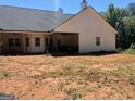 This backyard features a covered patio and a level yard, perfect for entertaining at 1333 Happy Hill Rd, Carrollton, GA 30116