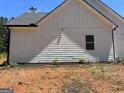 A close up of the side exterior of this white farmhouse-style home at 1333 Happy Hill Rd, Carrollton, GA 30116