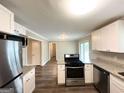 Well-lit kitchen with stainless steel appliances, granite countertops, and an adjacent living area at 3948 Regent St, Douglasville, GA 30134