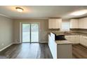 Bright kitchen with stainless steel appliances, granite countertops, and stylish wood-look flooring at 3948 Regent St, Douglasville, GA 30134