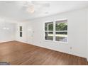 Inviting living area with hardwood floors, white walls, and windows offering outdoor views at 150 Glynn Addy Dr, Stockbridge, GA 30281