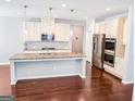 Spacious kitchen features granite countertops, stainless steel appliances, and a large center island at 5229 Tye, Fairburn, GA 30213