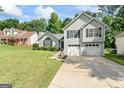 Beautifully landscaped front yard leads to this cozy two-story home with an attached two-car garage at 5832 Whitney Way, Rex, GA 30273