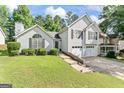 Inviting two-story home featuring a well-maintained lawn and a convenient two-car garage at 5832 Whitney Way, Rex, GA 30273
