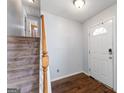 Inviting foyer with hardwood floors, staircase and door, showcasing a warm and welcoming entrance at 5832 Whitney Way, Rex, GA 30273
