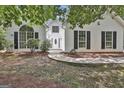 Inviting home exterior featuring a decorative glass front door, complemented by an arch window and dark shutters at 288 Winthrop Dr, Sharpsburg, GA 30277