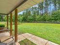 Covered porch area featuring a spacious view of the backyard, perfect for outdoor relaxation and gatherings at 552 New Hope Rd, Mcdonough, GA 30252