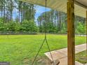 View of the expansive, fenced backyard from the covered porch, showcasing the lush greenery and privacy at 552 New Hope Rd, Mcdonough, GA 30252