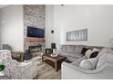 Comfortable living room with stone fireplace, gray sofa, and wood-look flooring at 4527 Village Springs Run, Dunwoody, GA 30338