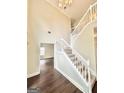 Bright foyer with soaring ceilings, wooden floors, and a staircase leading to the upper level at 759 Hennepin Ter, Mcdonough, GA 30253