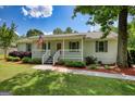 Charming home features a well-manicured lawn, an inviting porch, and delightful landscaping for great curb appeal at 1130 Rawlings Dr, Rutledge, GA 30663