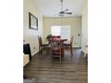 This dining room features dark hardwood floors and an elegant ceiling fan at 5814 Highgrove Dr, Atlanta, GA 30349