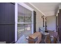 Cozy front porch featuring a window with blinds and comfortable seating area at 8321 Banks Mill Rd, Douglasville, GA 30135