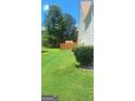 Spacious backyard featuring a lush green lawn, privacy fence, and mature trees at 7314 Basalt Dr, Union City, GA 30291