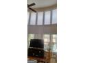 Bright living room with large windows, a ceiling fan, and a comfortable seating area at 7314 Basalt Dr, Union City, GA 30291
