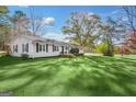 Relaxing outdoor scenery of a ranch style home with a spacious green lawn at 308 Lee Thompson Rd, Moreland, GA 30259