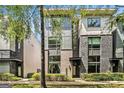 Contemporary townhome showcasing a blend of brick and modern siding and professionally landscaped front yard at 710 Oakview Rd, Decatur, GA 30030