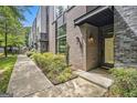 Townhome with a brick and modern facade, complemented by a well-maintained walkway and landscaping at 710 Oakview Rd, Decatur, GA 30030