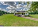 View of house with large yard featuring a covered parking structure on the side at 2809 South Ola Rd, Locust Grove, GA 30248